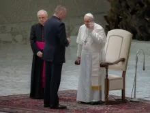 Pope Francis spoke on the phone at the end of his general audience Aug. 11, 2021.
